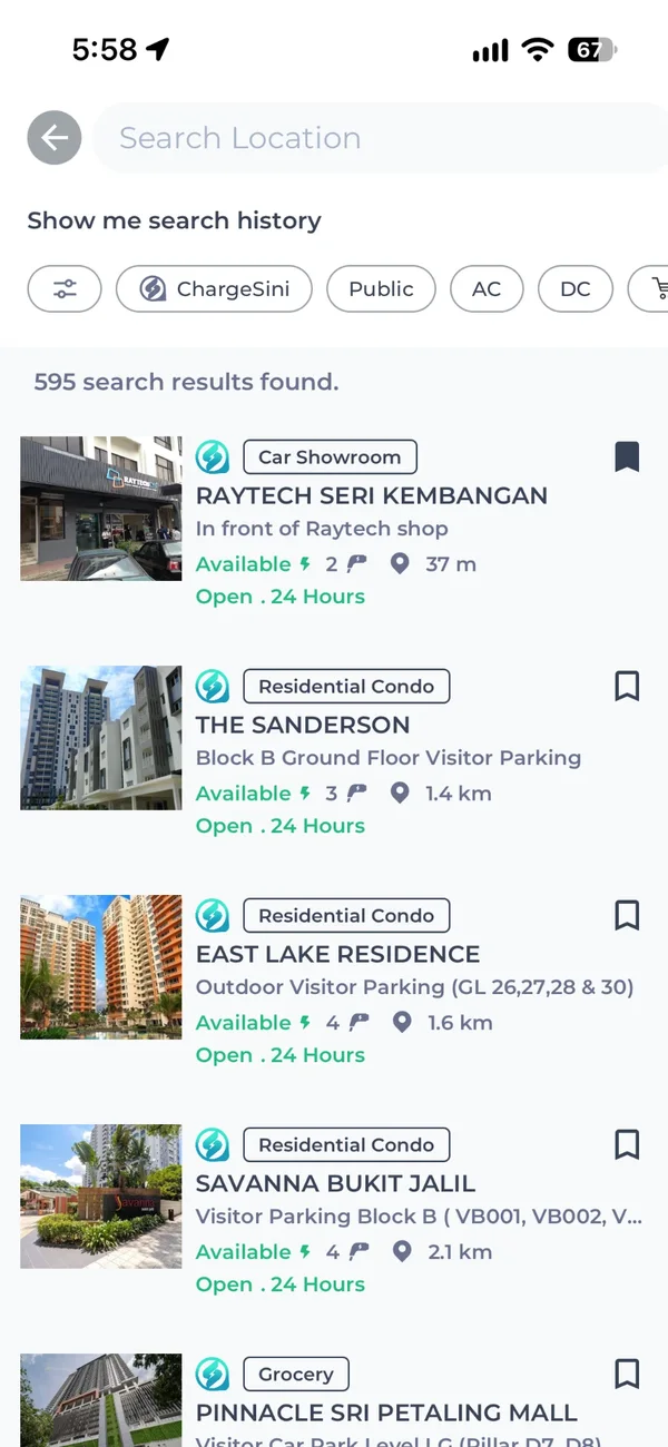 ChargeSini app search results listing nearby charging stations with venue type, free bays and distance